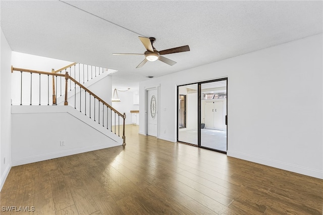 unfurnished living room featuring ceiling fan, a textured ceiling, and hardwood / wood-style floors