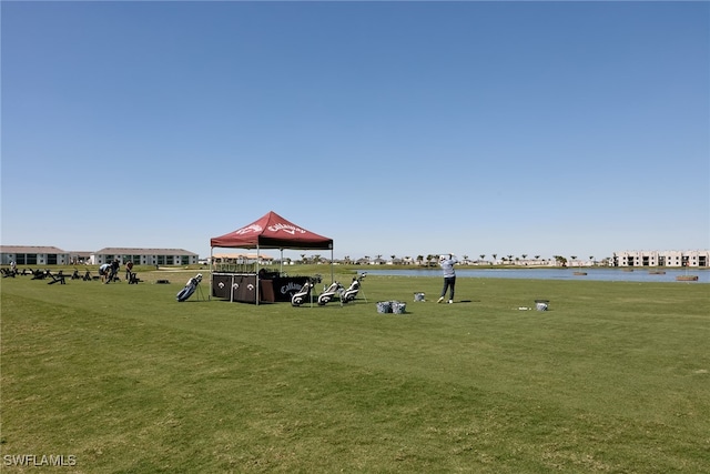 view of home's community with a lawn and a water view