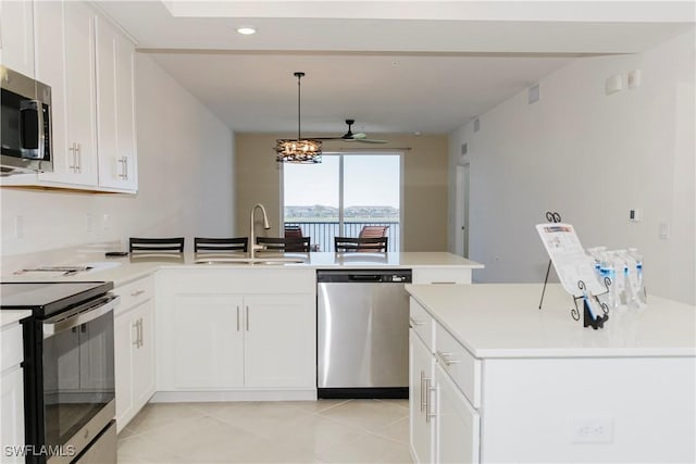 kitchen featuring stainless steel appliances, white cabinetry, ceiling fan, and sink