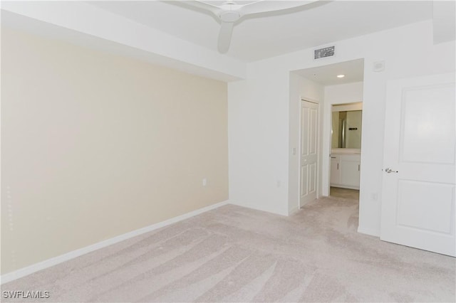 spare room with light colored carpet and ceiling fan