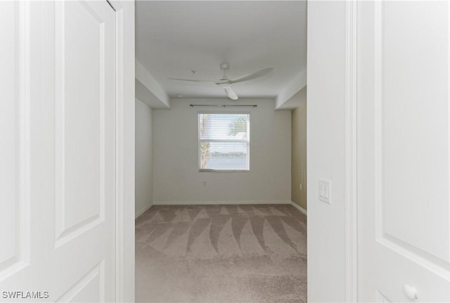 carpeted spare room with ceiling fan