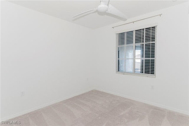 empty room with ceiling fan and light colored carpet