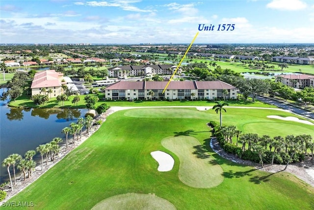drone / aerial view featuring a residential view, a water view, and view of golf course