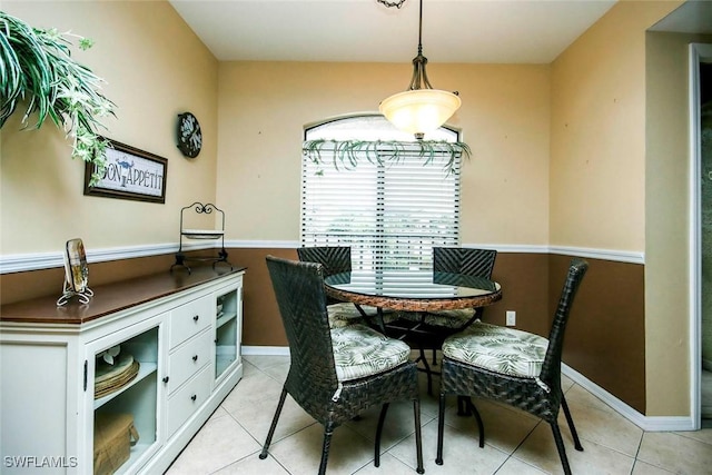 dining room featuring light tile patterned flooring and baseboards