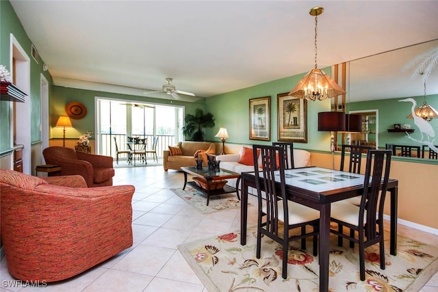 dining area with light tile patterned floors and ceiling fan with notable chandelier