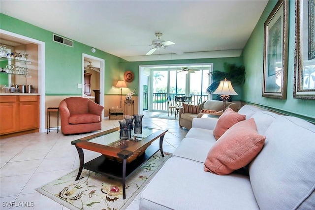 tiled living room featuring ceiling fan and built in features