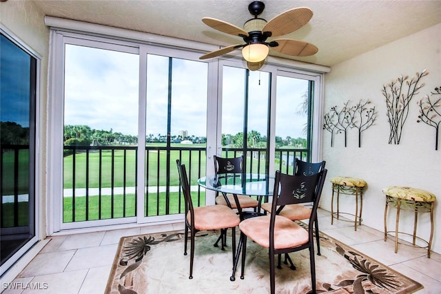 sunroom / solarium featuring ceiling fan