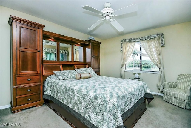 carpeted bedroom featuring ceiling fan and baseboards