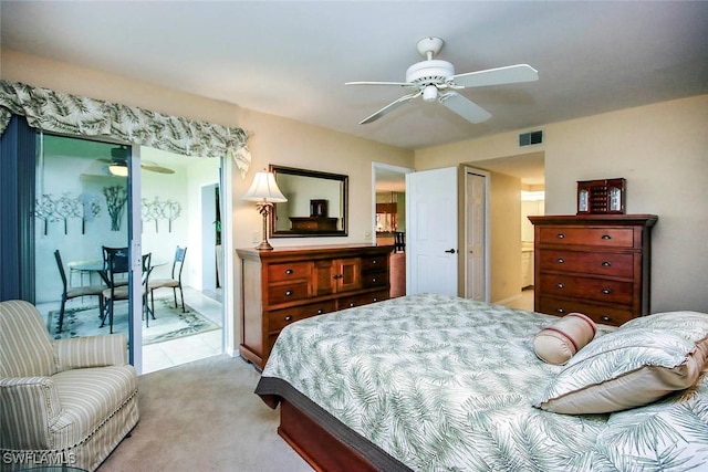 bedroom featuring visible vents, a ceiling fan, and light colored carpet
