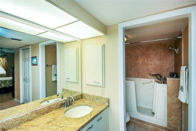 bathroom featuring tile patterned floors, vanity, toilet, and visible vents