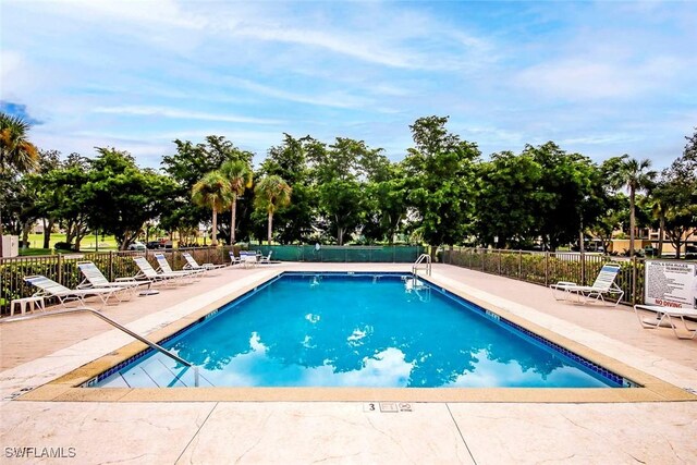 pool with fence and a patio area