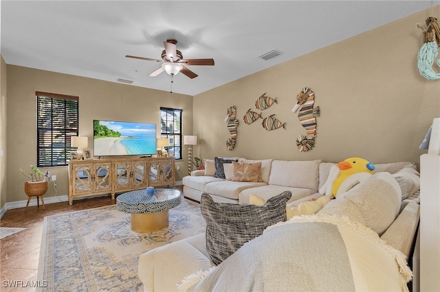 living room with ceiling fan and tile patterned floors