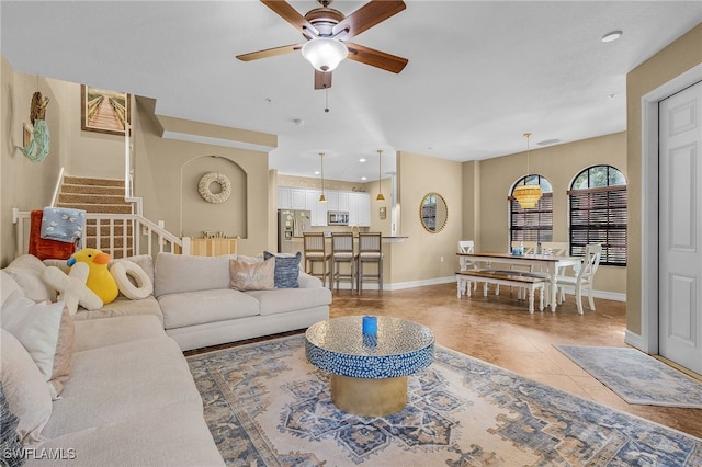 tiled living room with ceiling fan