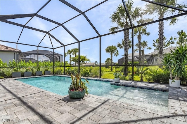 view of swimming pool with a lanai and a patio area