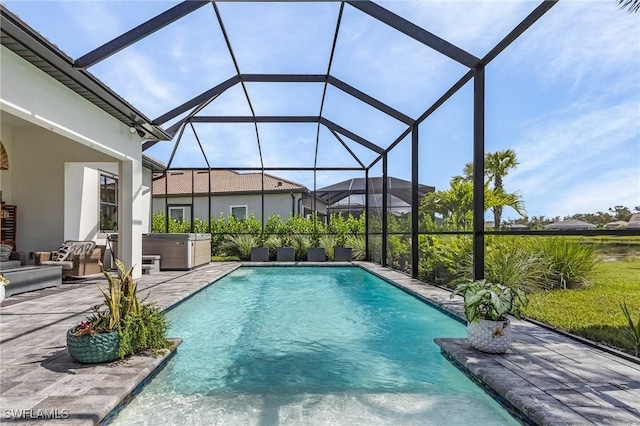 view of pool featuring a lanai, a hot tub, and a patio