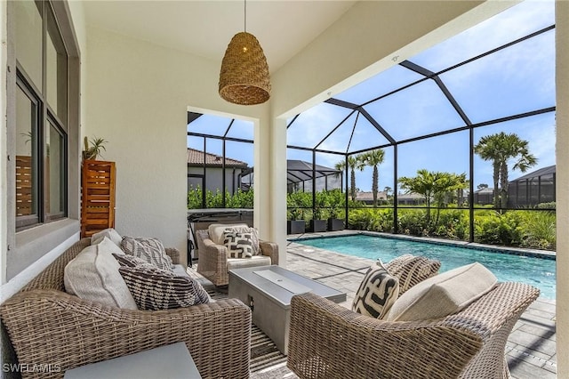 view of pool with outdoor lounge area, a hot tub, a patio, and a lanai