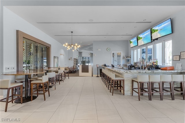 tiled dining room with an inviting chandelier