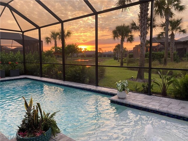 pool at dusk with a lanai