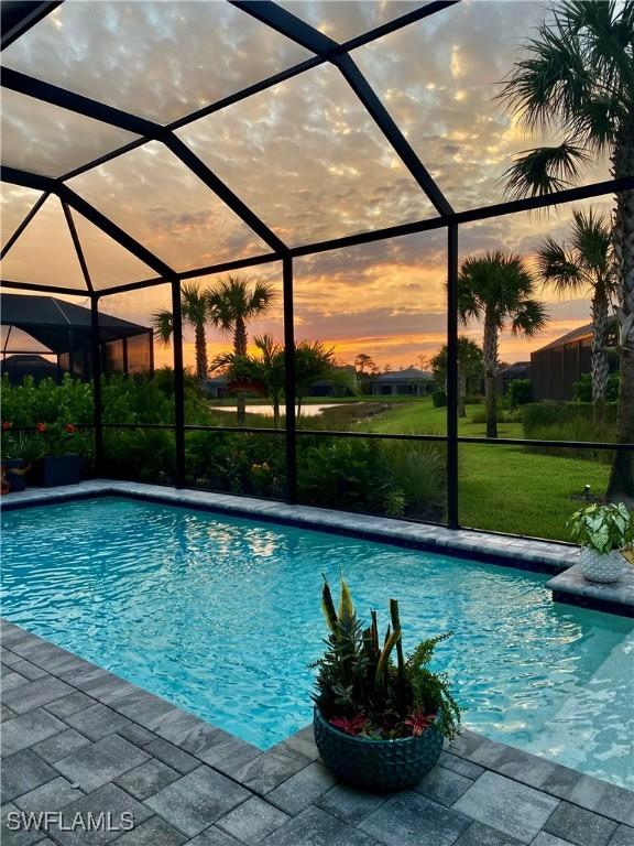 pool at dusk with a lanai