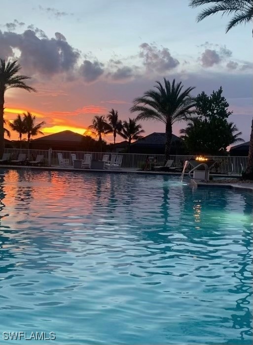 view of pool at dusk