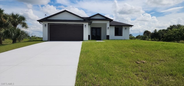 view of front of property featuring a garage and a front yard