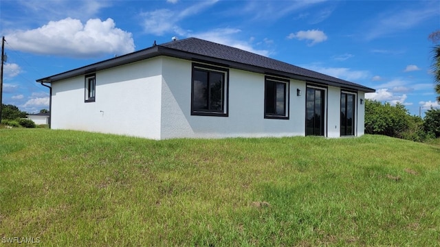 back of house with a lawn