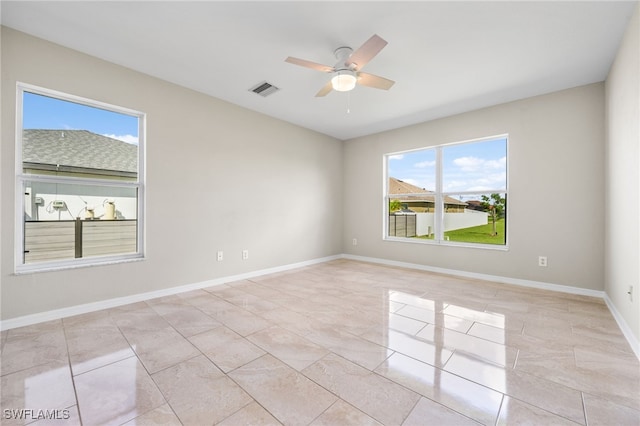 spare room with plenty of natural light and ceiling fan