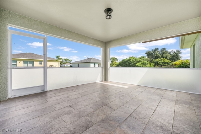 unfurnished sunroom featuring plenty of natural light