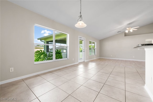 interior space featuring ceiling fan, light tile patterned flooring, and lofted ceiling