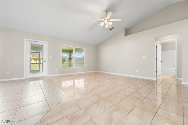 tiled empty room with vaulted ceiling and ceiling fan