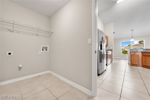 clothes washing area with hookup for a washing machine, light tile patterned floors, and hookup for an electric dryer