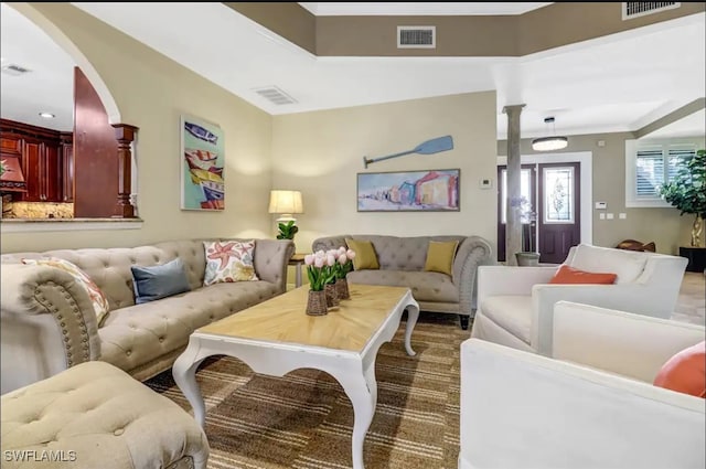 living room featuring ornate columns