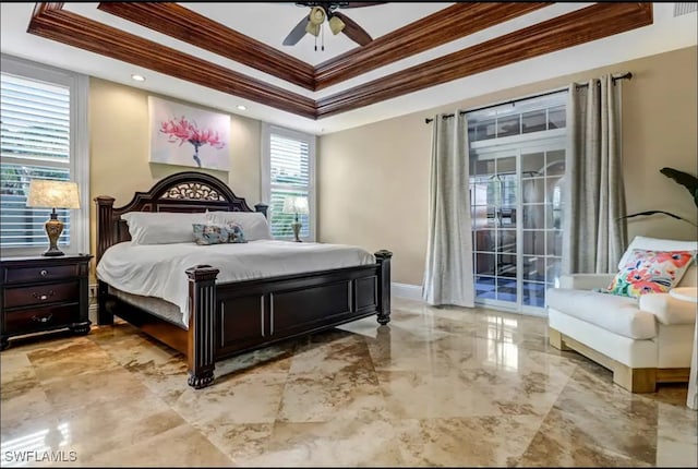 bedroom with ornamental molding, a tray ceiling, and ceiling fan