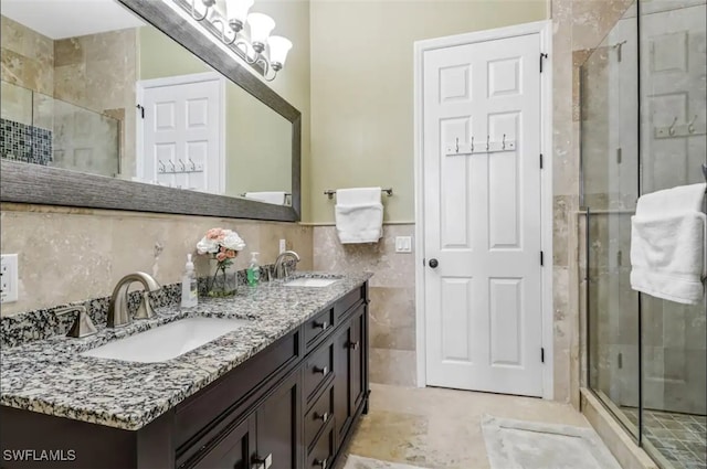 bathroom featuring tile walls, vanity, and a shower with door