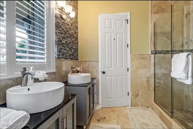 bathroom with tile walls, vanity, and an enclosed shower