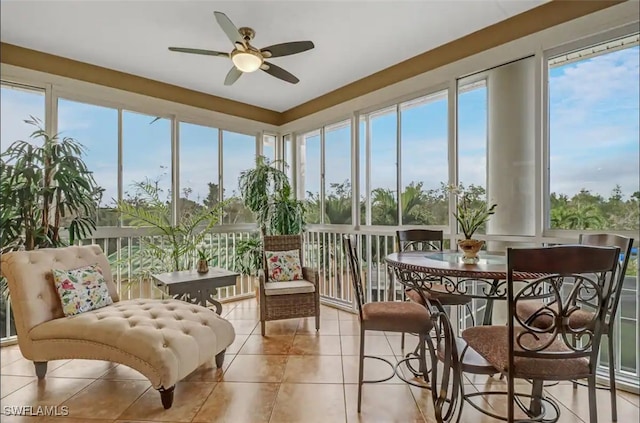 sunroom / solarium featuring ceiling fan