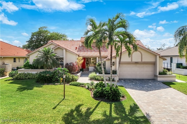 view of front of property featuring a garage and a front lawn