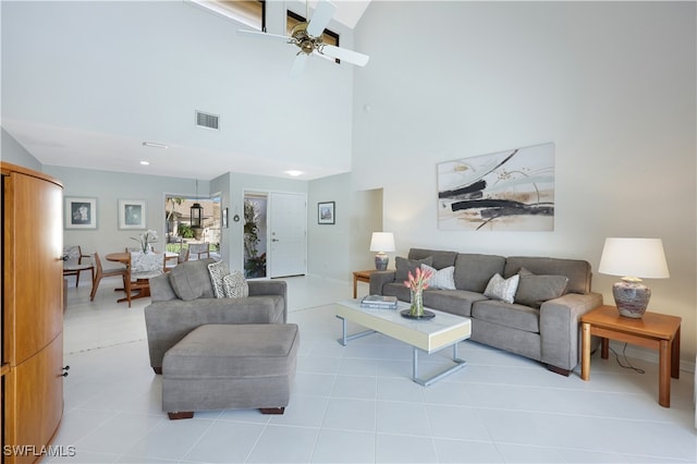 tiled living room with high vaulted ceiling and ceiling fan