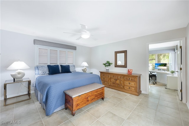 tiled bedroom featuring ceiling fan