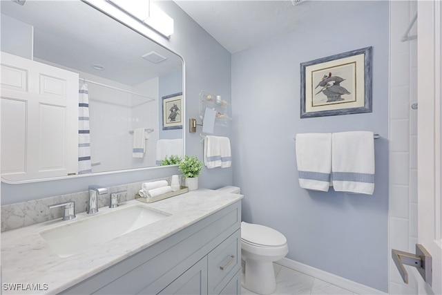 bathroom featuring vanity, toilet, and walk in shower