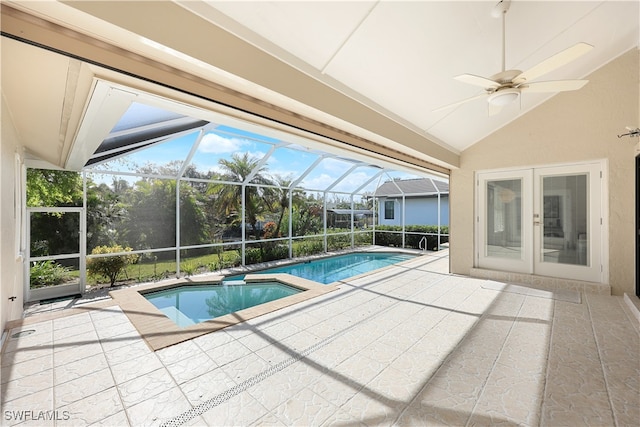 view of pool featuring ceiling fan, a patio, glass enclosure, and french doors