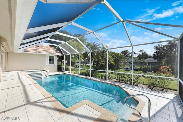 view of pool with a lanai, an in ground hot tub, and a patio