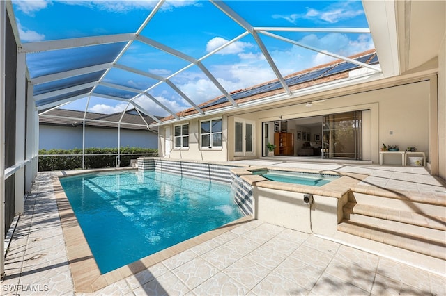 view of swimming pool featuring glass enclosure, an in ground hot tub, and a patio