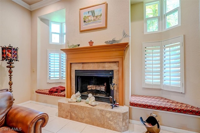 sitting room featuring a tile fireplace, tile patterned floors, and crown molding