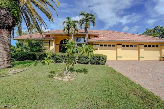 view of front of house with a garage and a front lawn