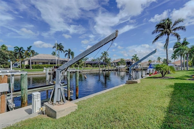 dock area featuring a lawn and a water view