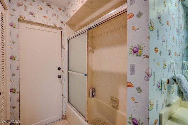 bathroom featuring combined bath / shower with glass door and tile patterned floors