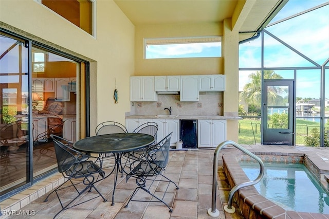 exterior space featuring a pool with hot tub and sink