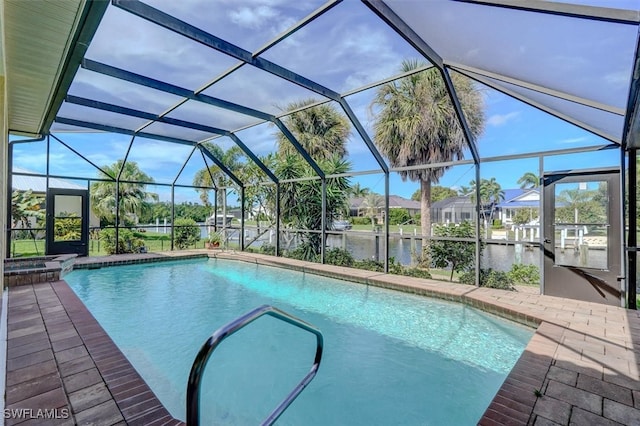 view of pool featuring a lanai, a water view, and a patio area