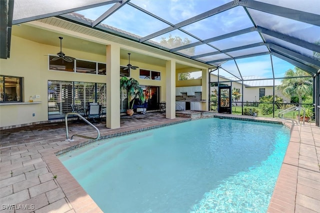 view of swimming pool with a lanai, ceiling fan, and a patio area